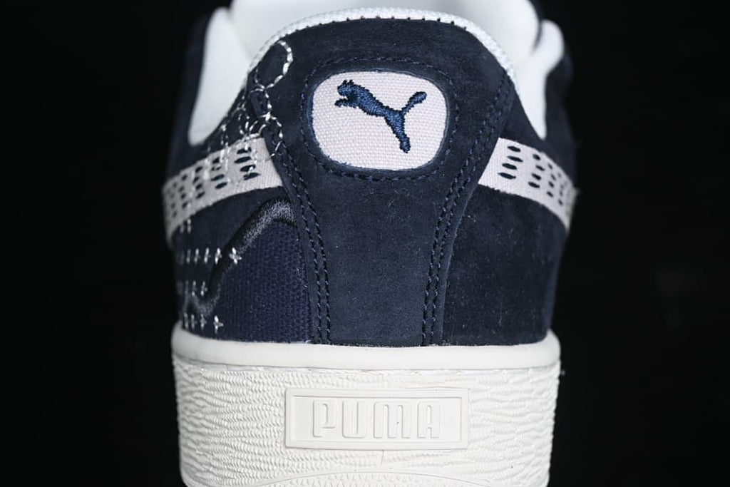 Rear view showing Puma heel branding and textured light-colored sole