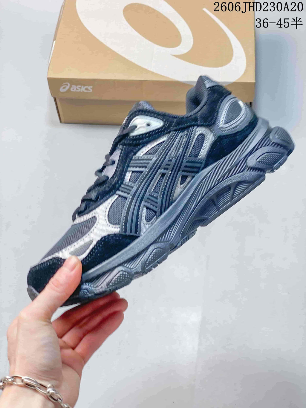 Side profile of a navy and silver ASICS GEL-NYC 2 sneaker