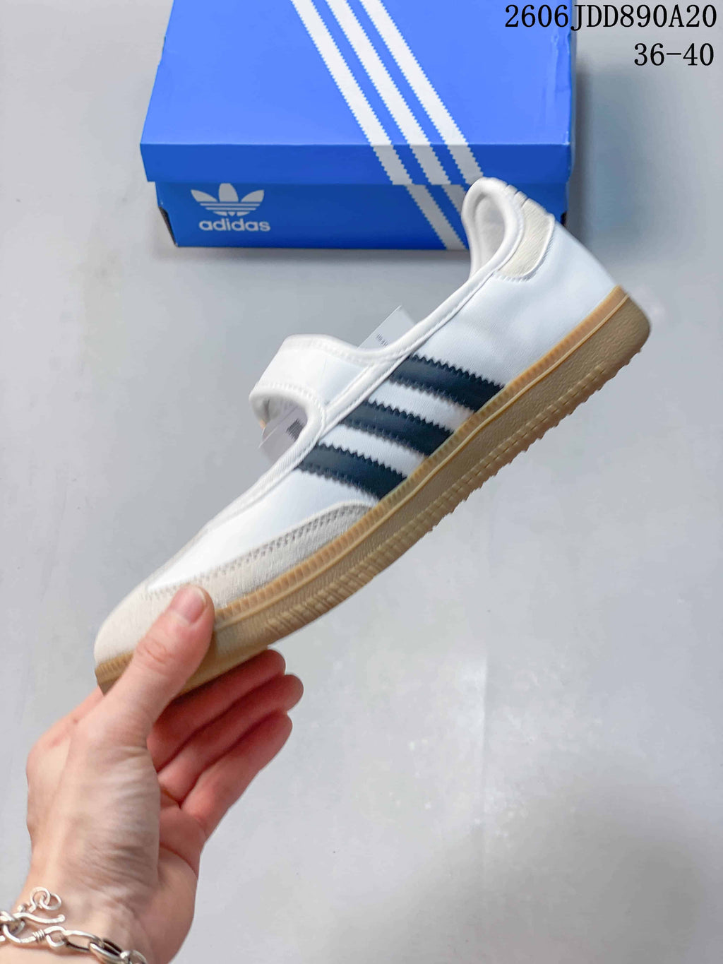 Side profile of the white Samba Jane with dark stripes, a Mary Jane strap, and gum-colored outsole.