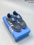 Dark grey Adidas Samba OG low-top sneakers with light side stripes on a blue box