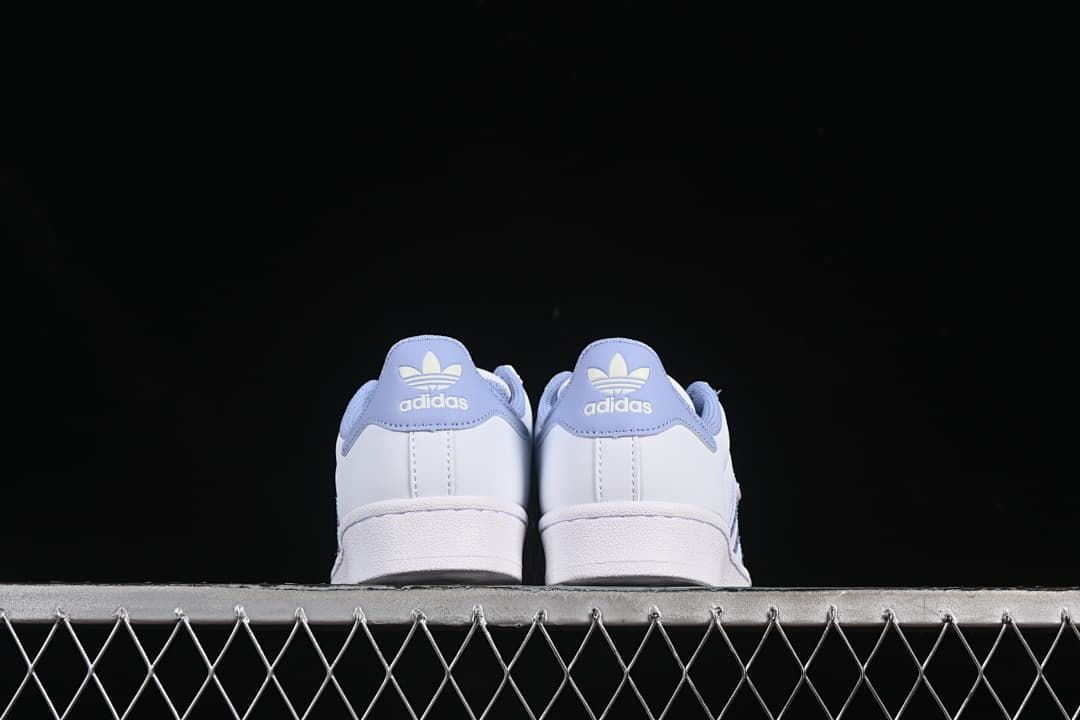 Rear view of both shoes showing lavender heel tabs