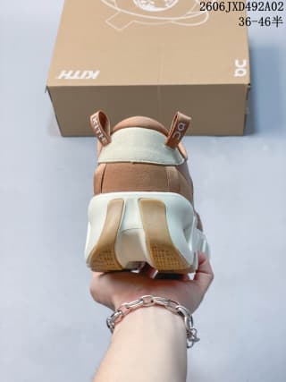 Rear view of the sneaker showing the heel pull tabs, layered heel panels, and segmented outsole.