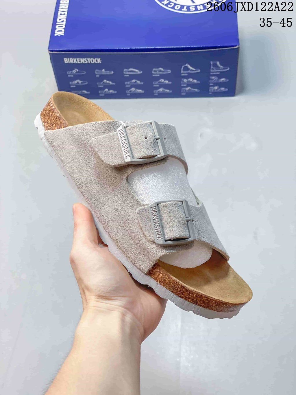 Angled view of a light taupe two-strap clog with a closed toe and open heel.