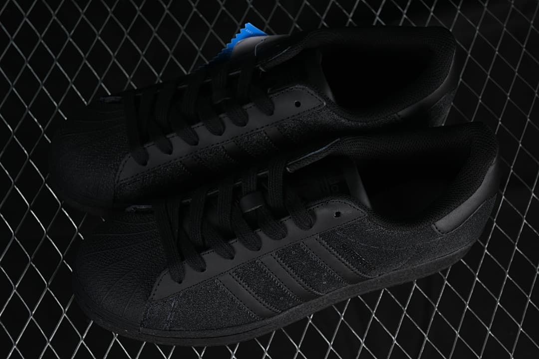 Pair of black adidas Superstar low-top sneakers viewed from above