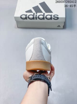 Rear view showing the white heel, textured gray heel panel, and gum-colored outsole.
