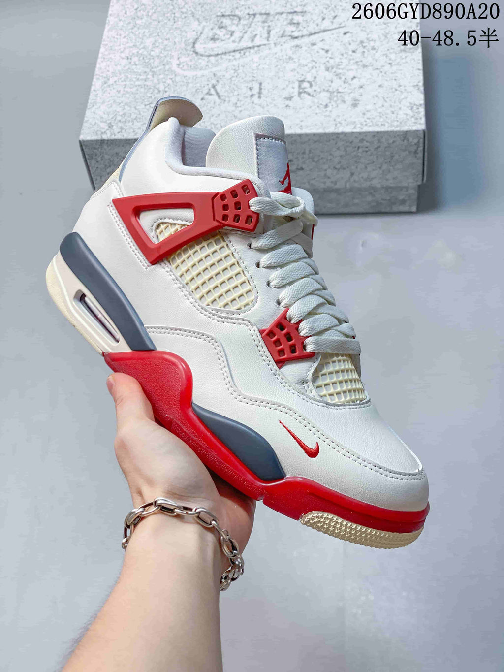 Close side view of the white, red, and blue-gray sneaker