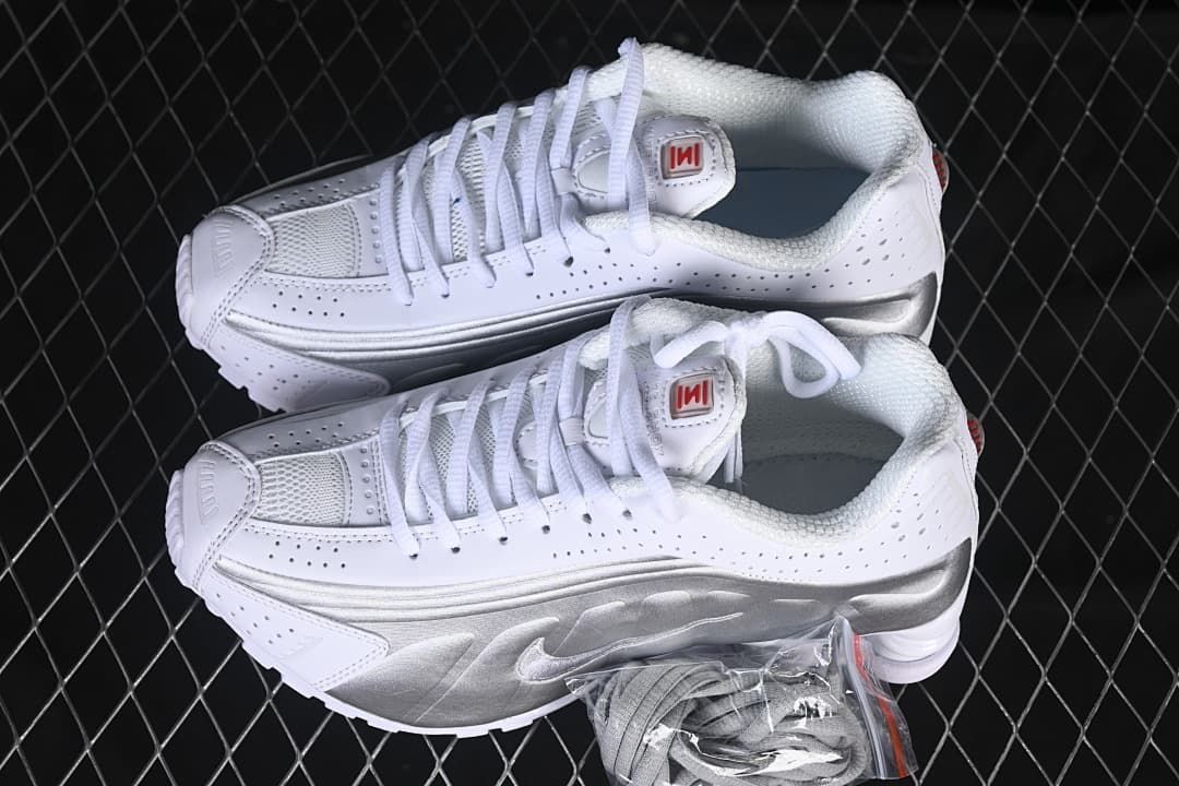 Pair of white and metallic silver sneakers shown from above