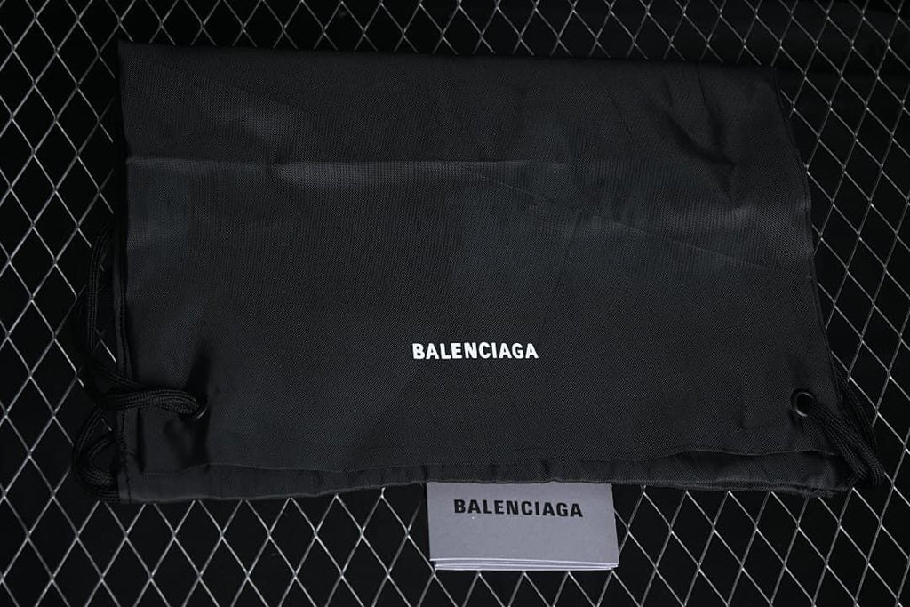 Black drawstring dust bag and paper insert labeled Balenciaga.