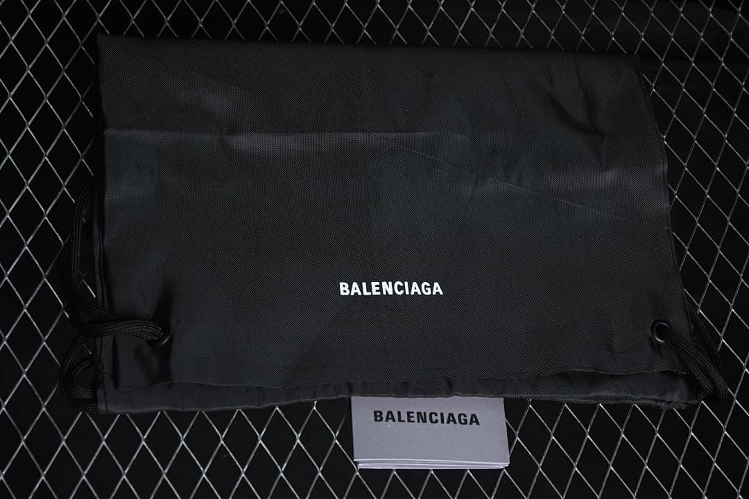 Black drawstring dust bag and paper insert labeled Balenciaga.
