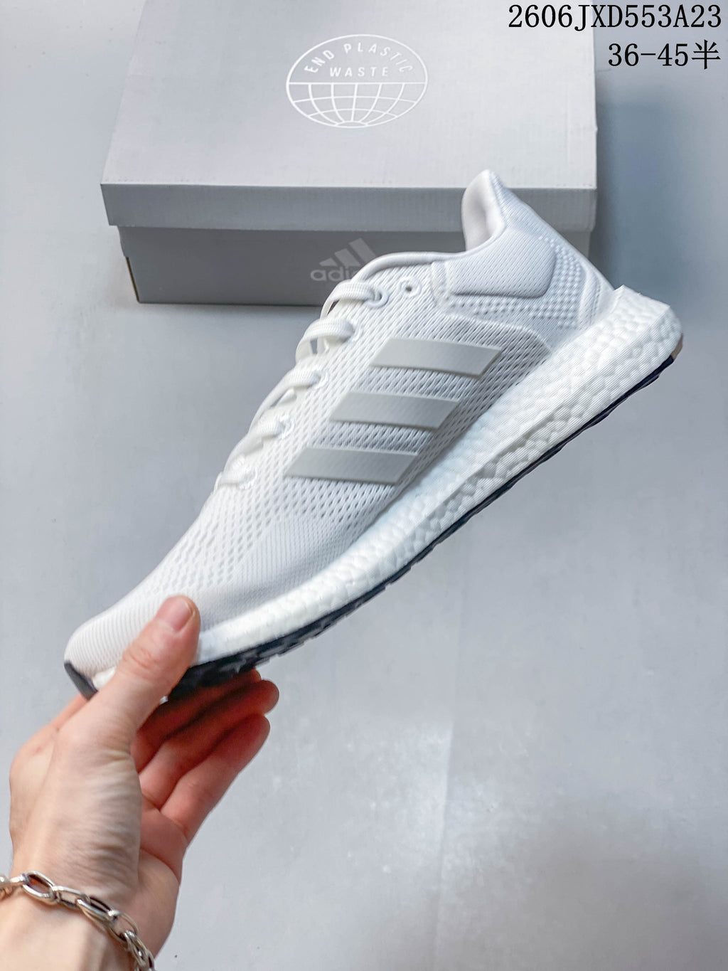 Side profile of a white Adidas PureBoost 21 running shoe