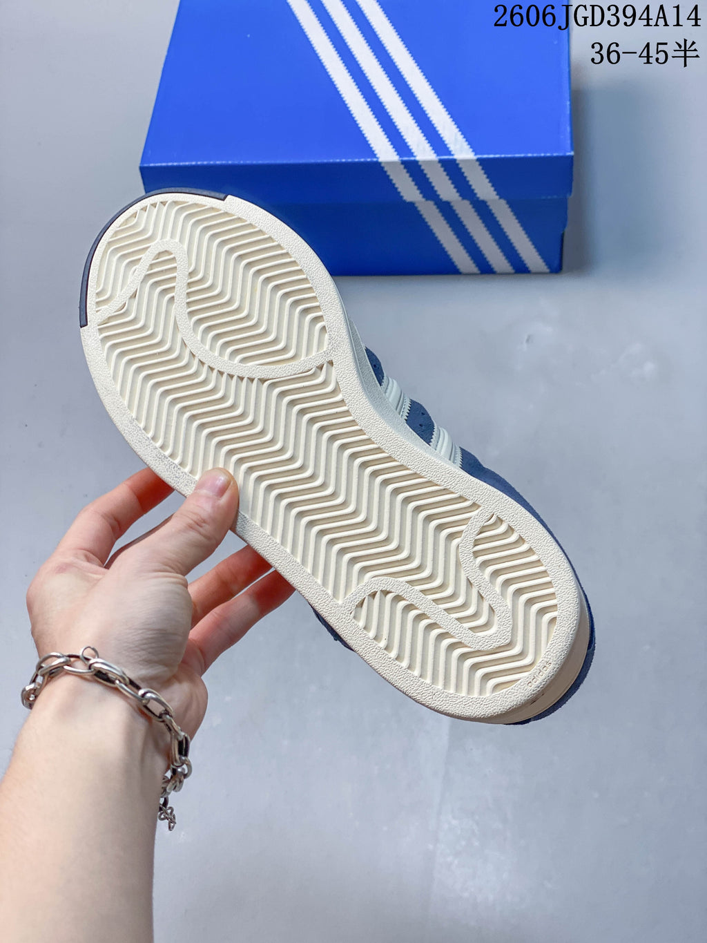 Underside of a sneaker showing a patterned off-white outsole