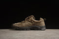 Side profile of a brown low-top CAT shoe with laces and a dark outsole.
