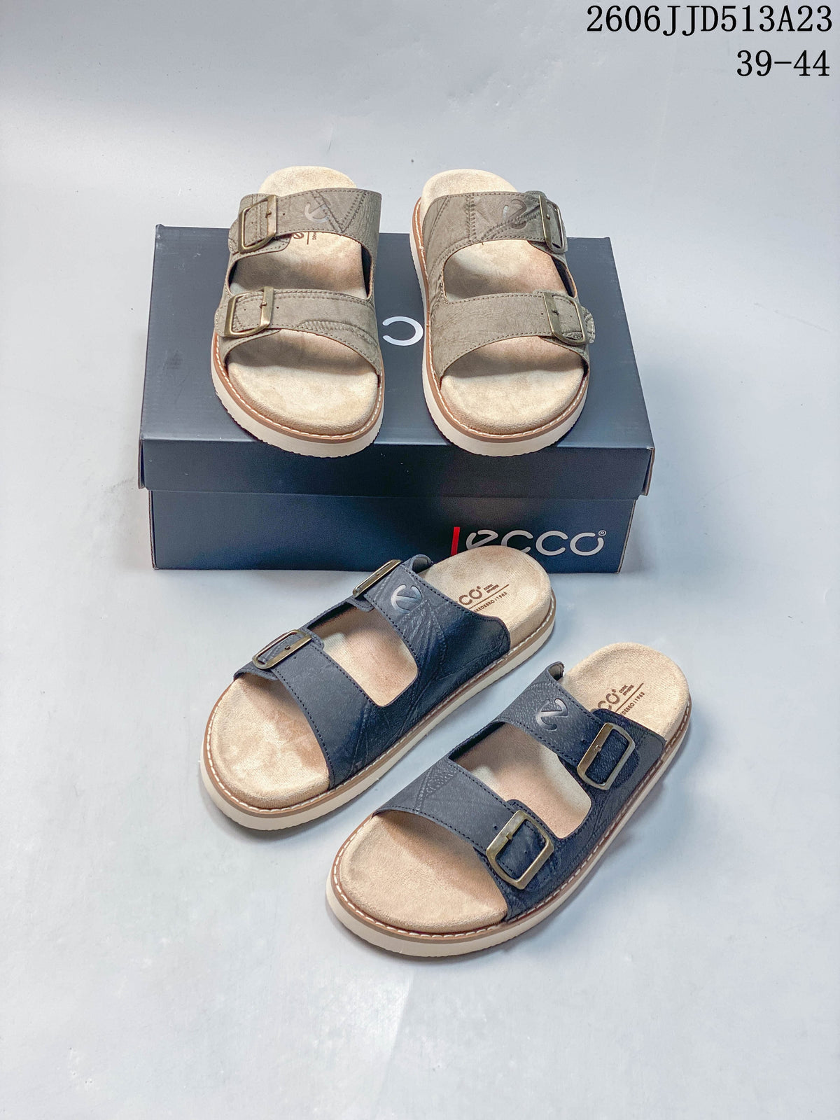 Taupe and dark blue-gray two-strap slide sandals shown together