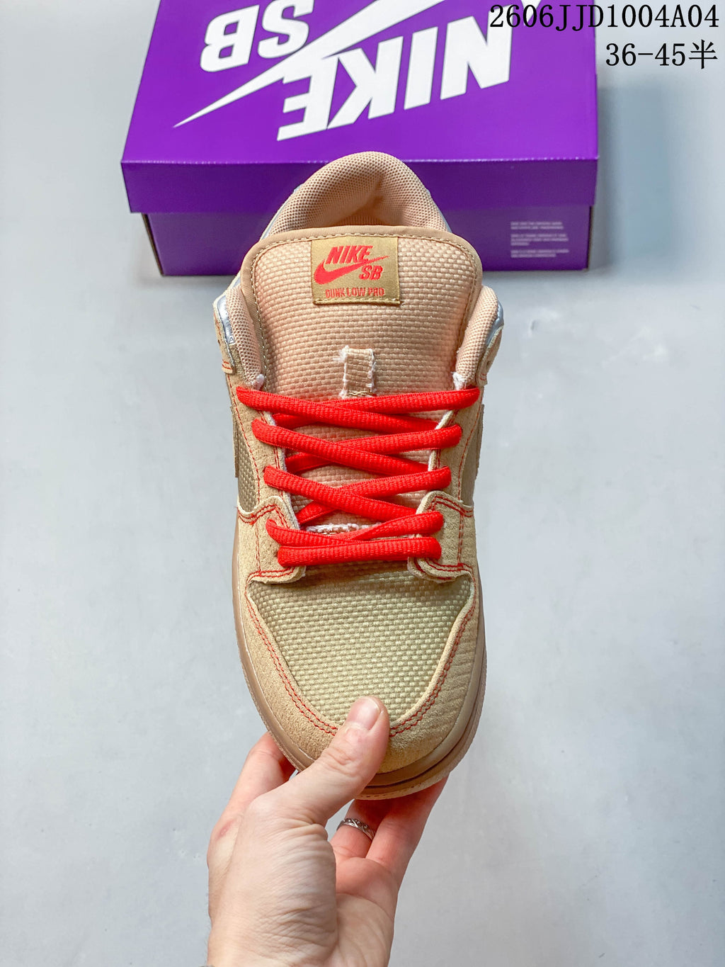 Top view showing the textured tongue, tan upper and red laces