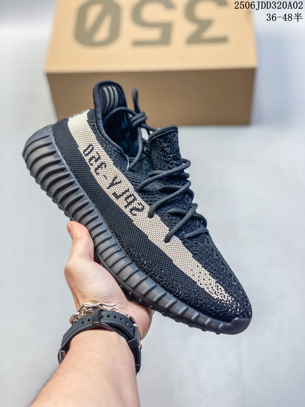 Black Adidas Yeezy-style sneaker with a beige side stripe