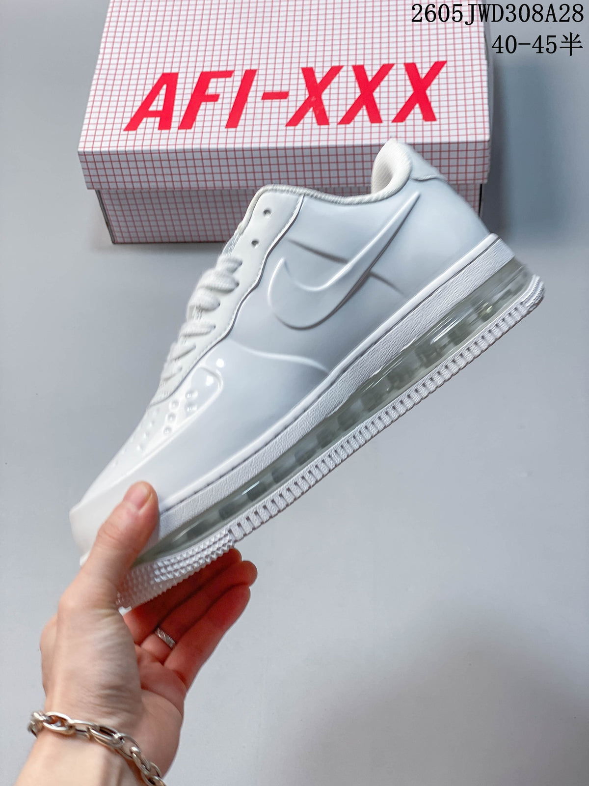 Side view of a white sneaker with a white Swoosh and visible heel cushioning