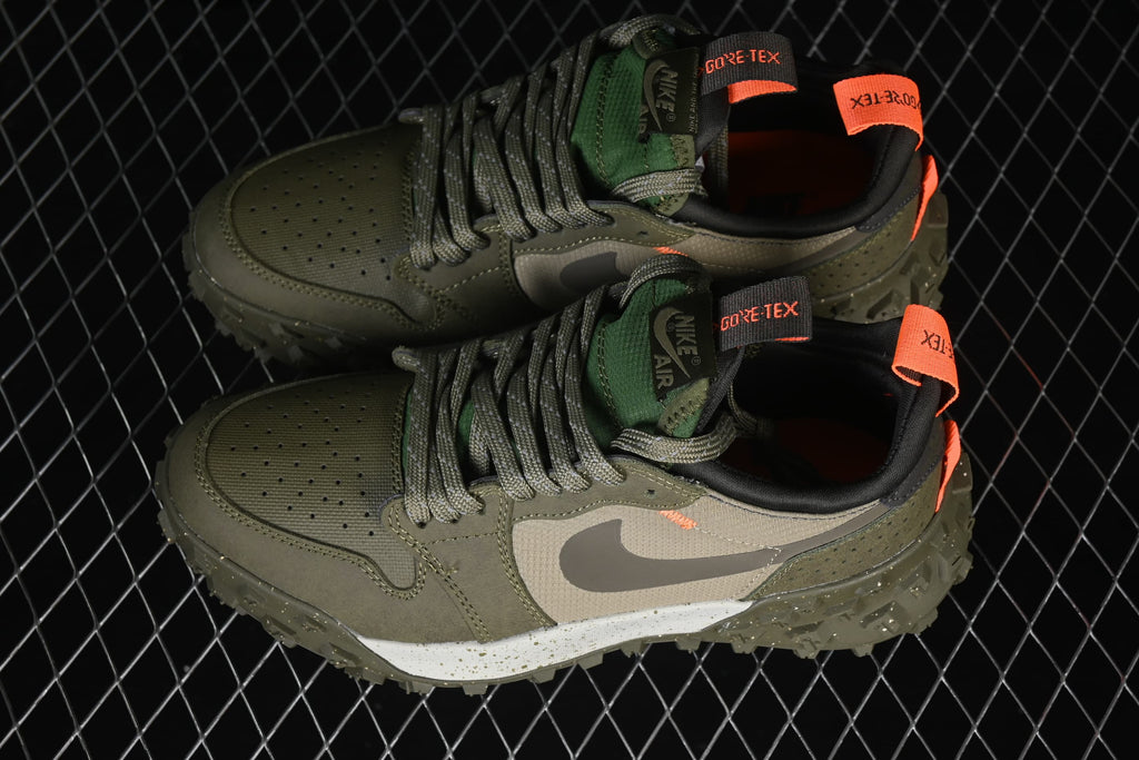 Top view of the pair highlighting green tongues, gray laces, and orange pull details.