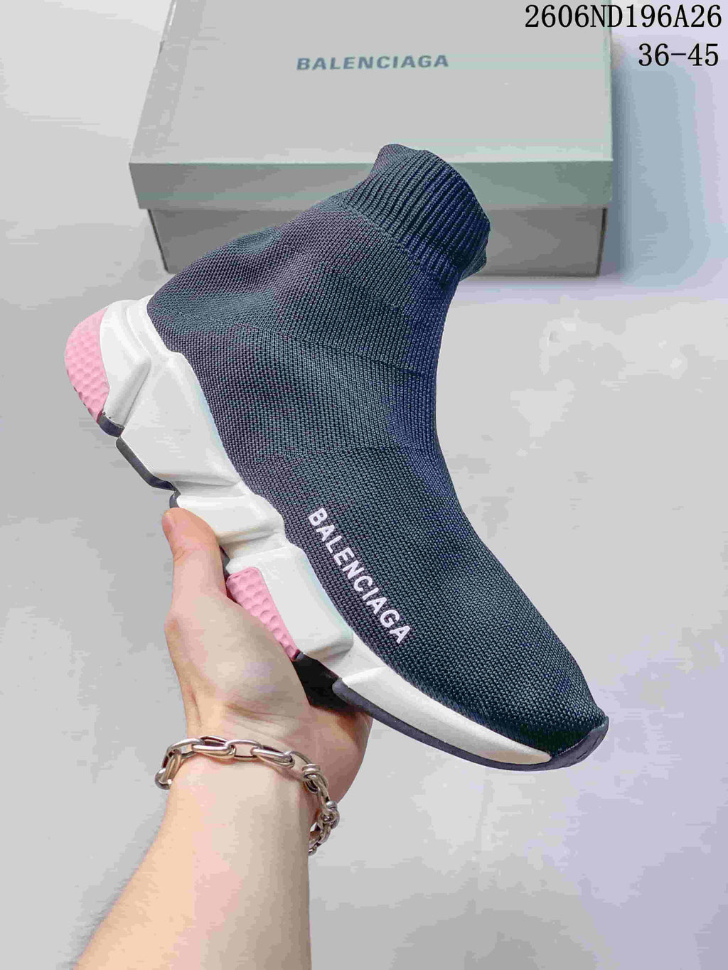 Dark blue knit sock sneaker with a white sole and pink accents
