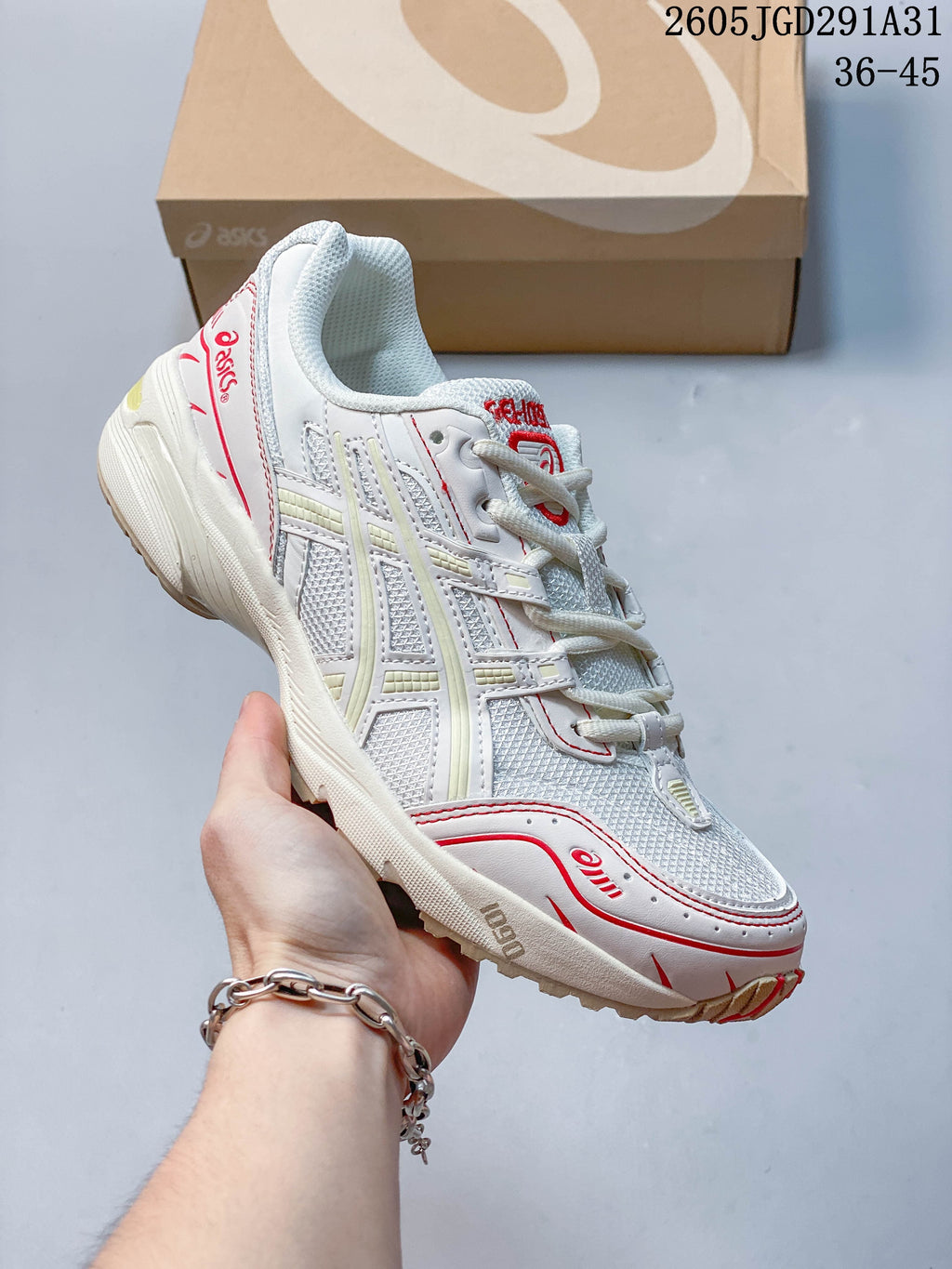 Angled side view of the white sneaker with mesh panels and red accents