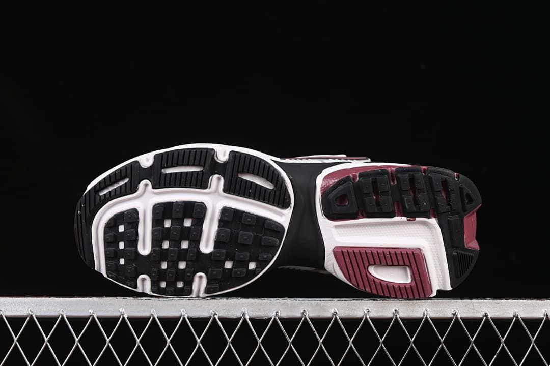 Underside view showing the black, white, and burgundy outsole
