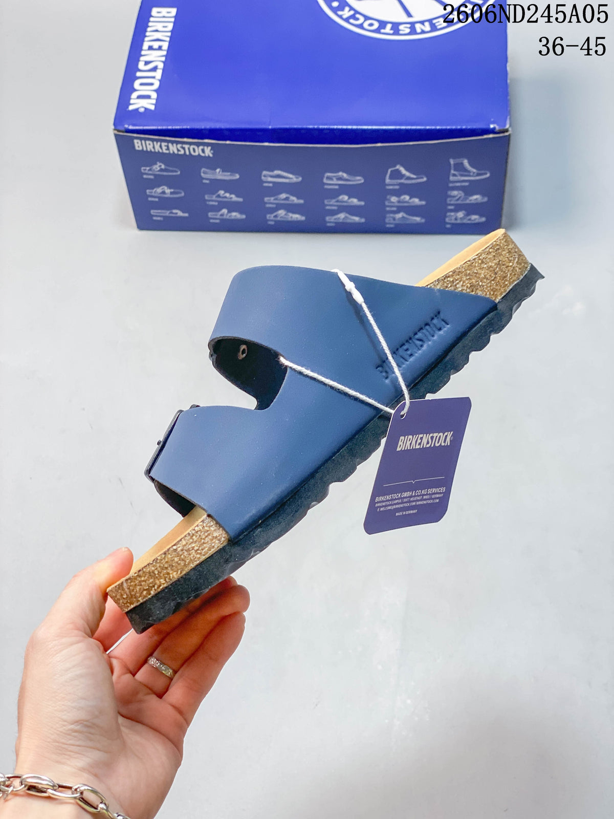 Side profile of the blue sandal showing its two adjustable straps and layered sole.