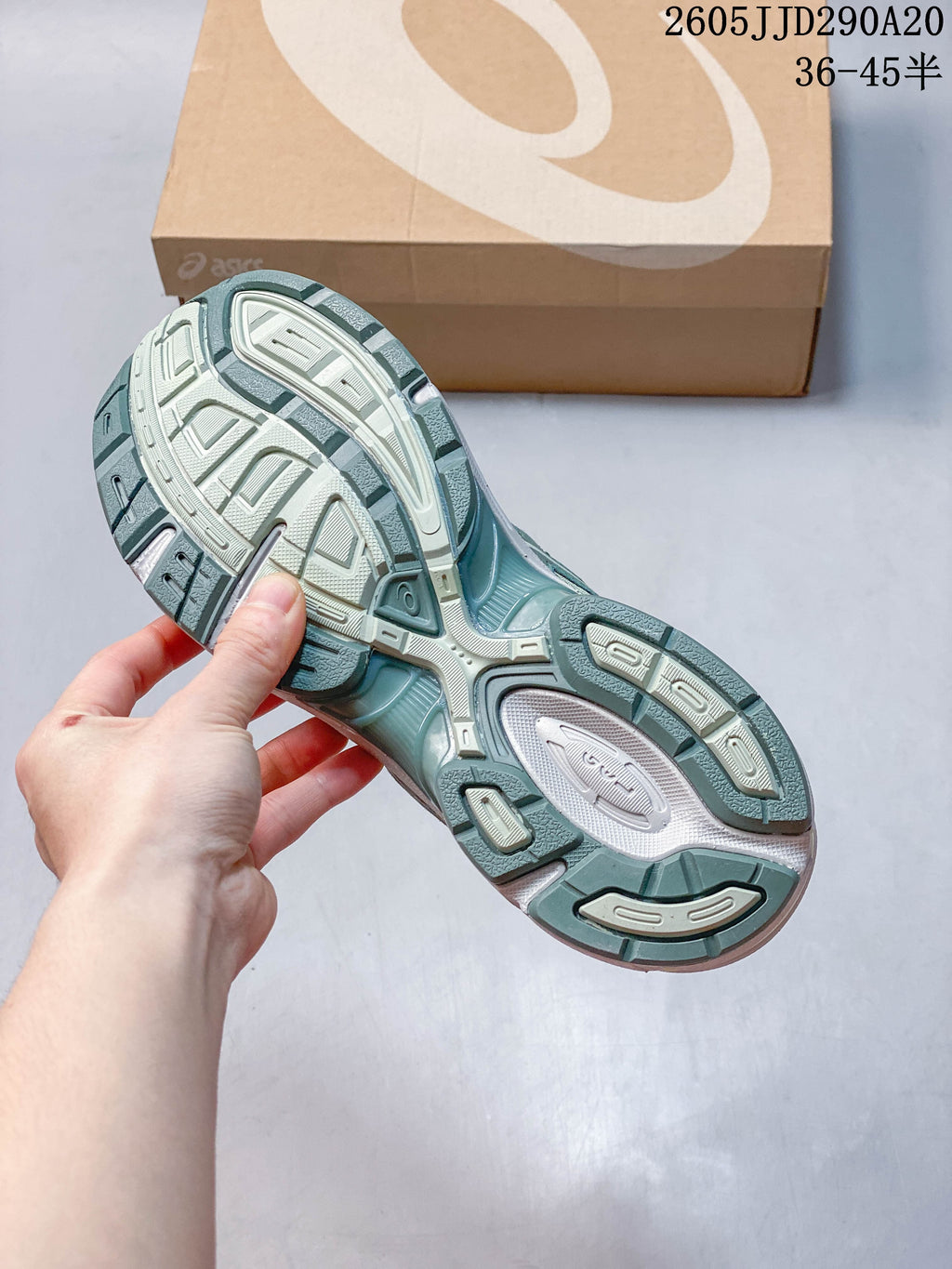 Outsole view of a sage-green ASICS GEL-1130 sneaker
