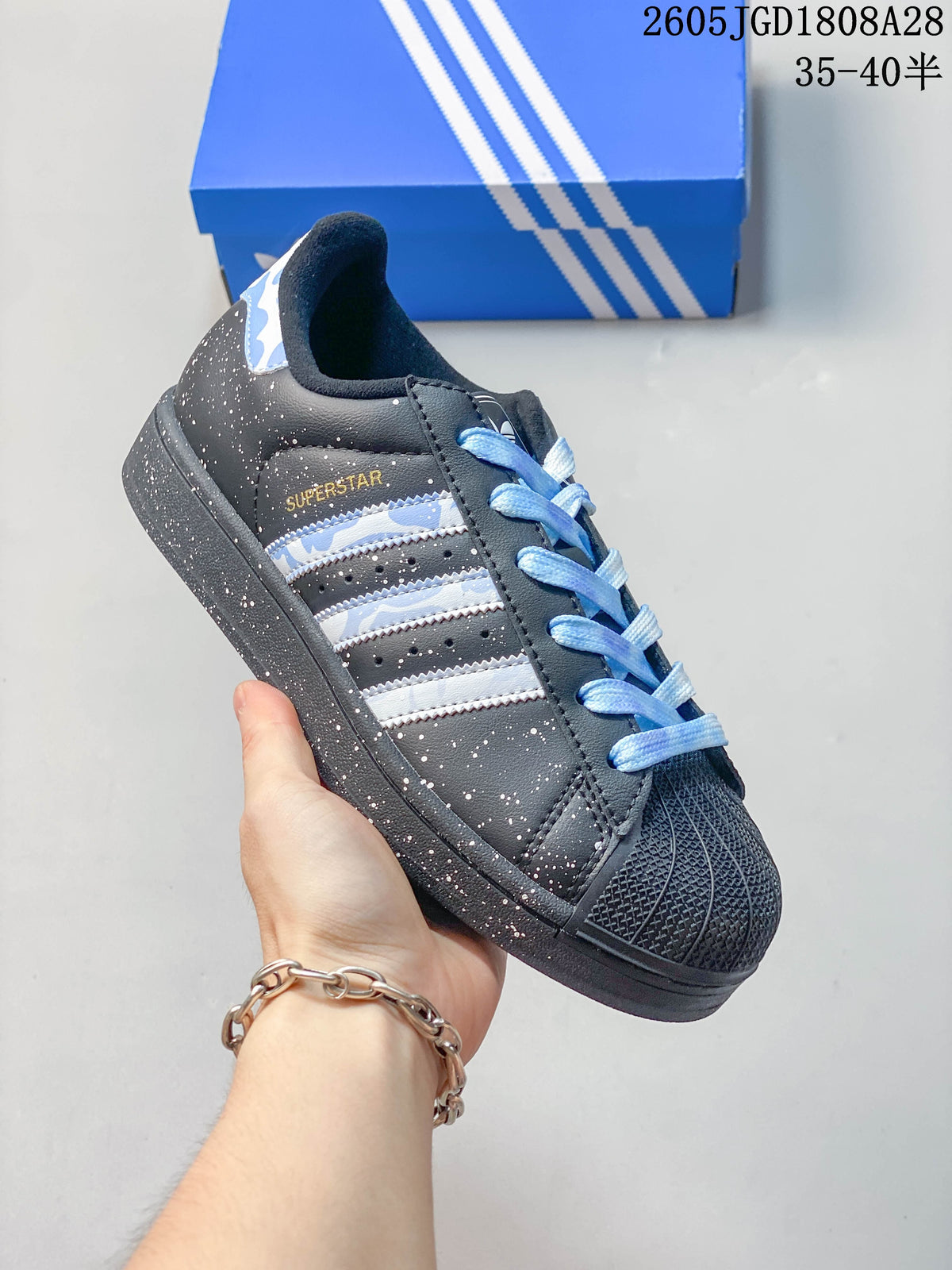 Angled side view highlighting the speckled upper, striped detailing, and shell-style toe