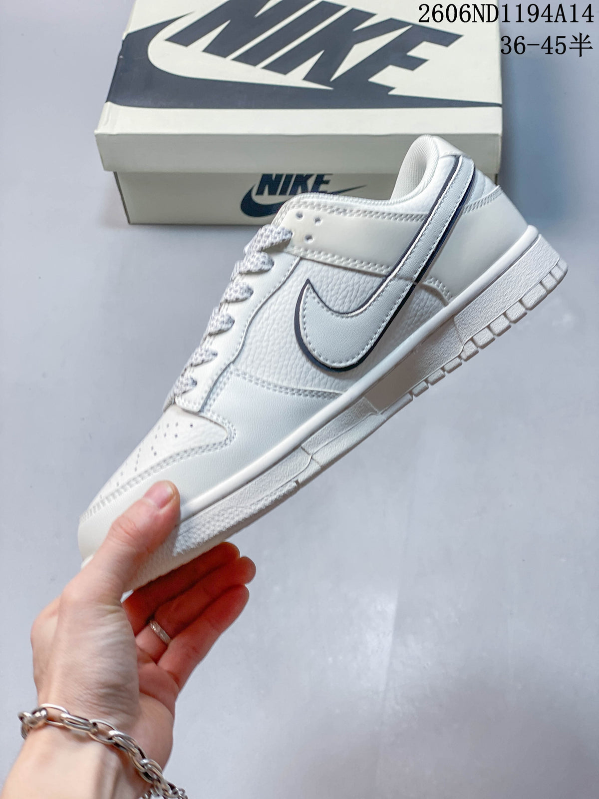 Side view of a white low-top sneaker with navy Swoosh detailing