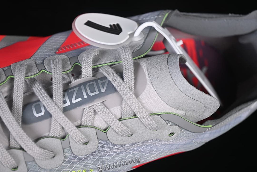 Close-up of gray laces, tongue and patterned upper