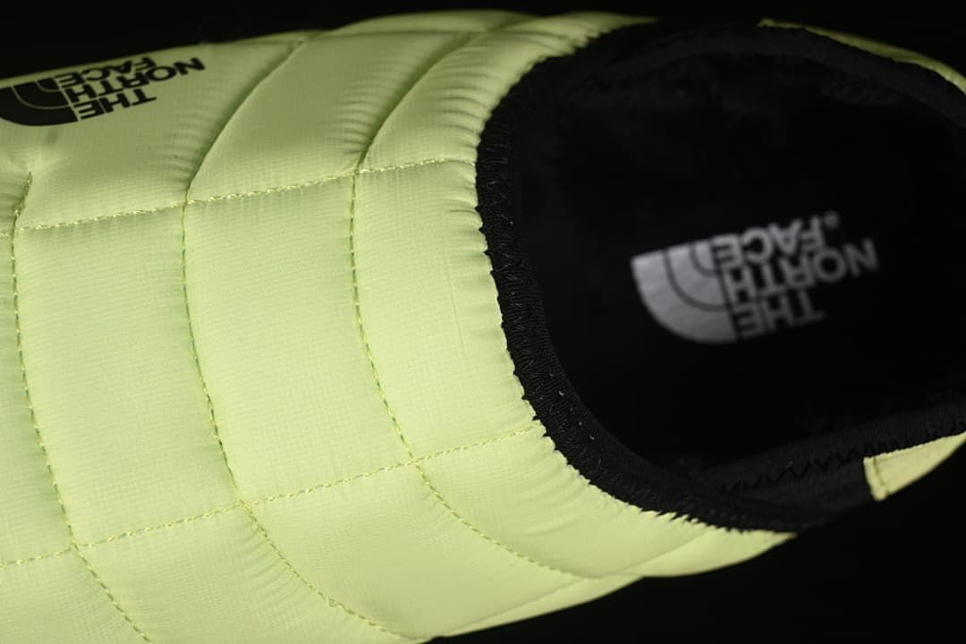 Top-down detail of the quilted upper and black shoe opening.
