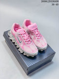 Pink and light gray Nike Air Liquid Max sneakers shown from above on a box.