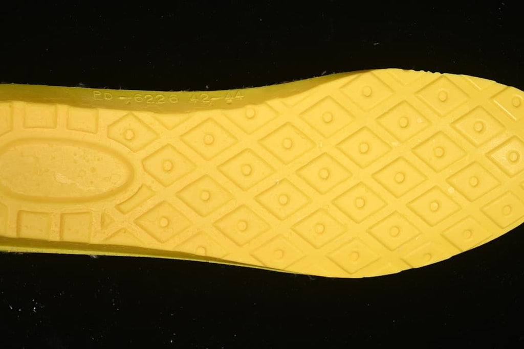 Close-up of the boot’s yellow outsole and geometric tread.