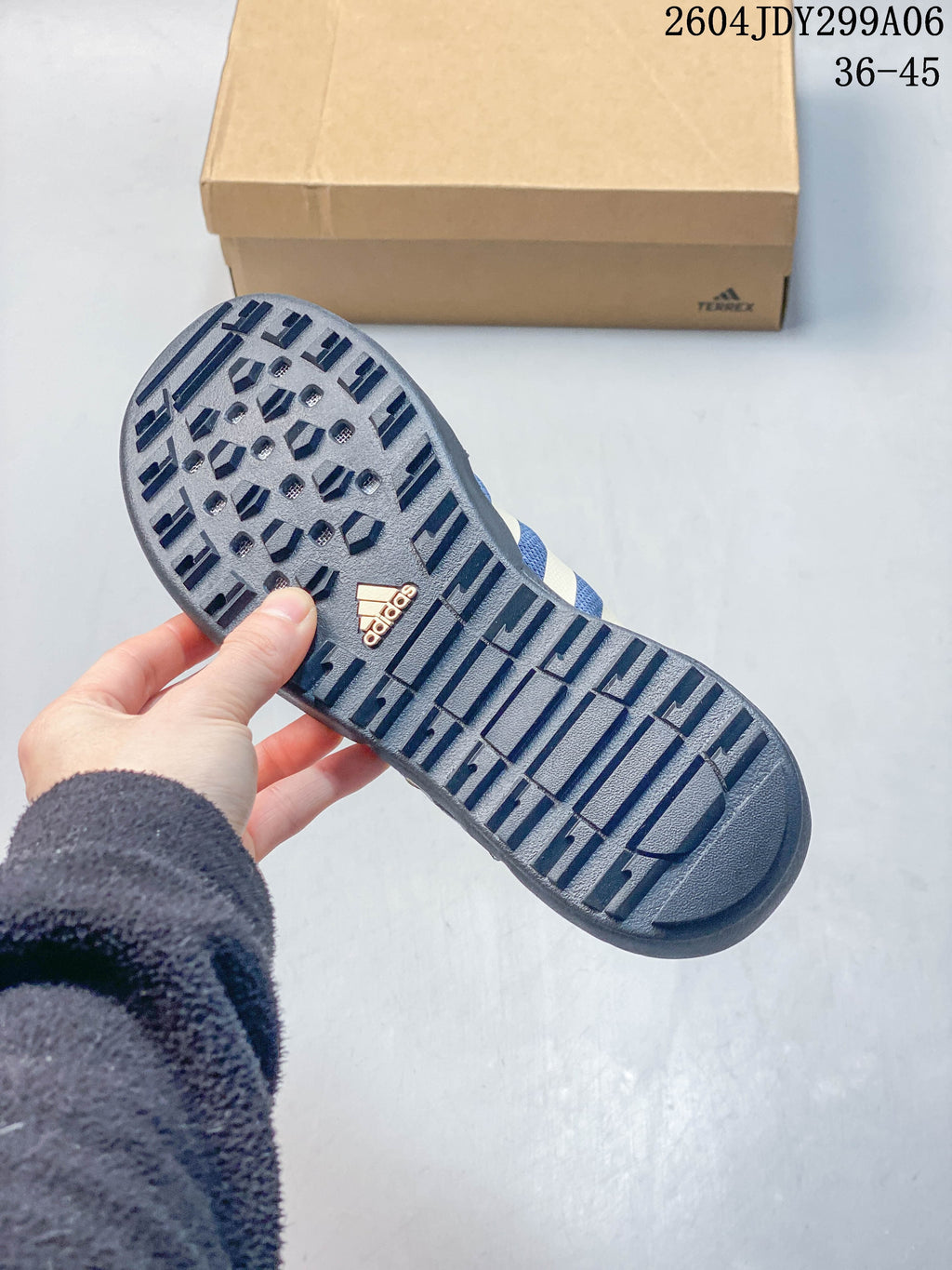 Close-up of the lugged outsole on a blue Adidas outdoor shoe