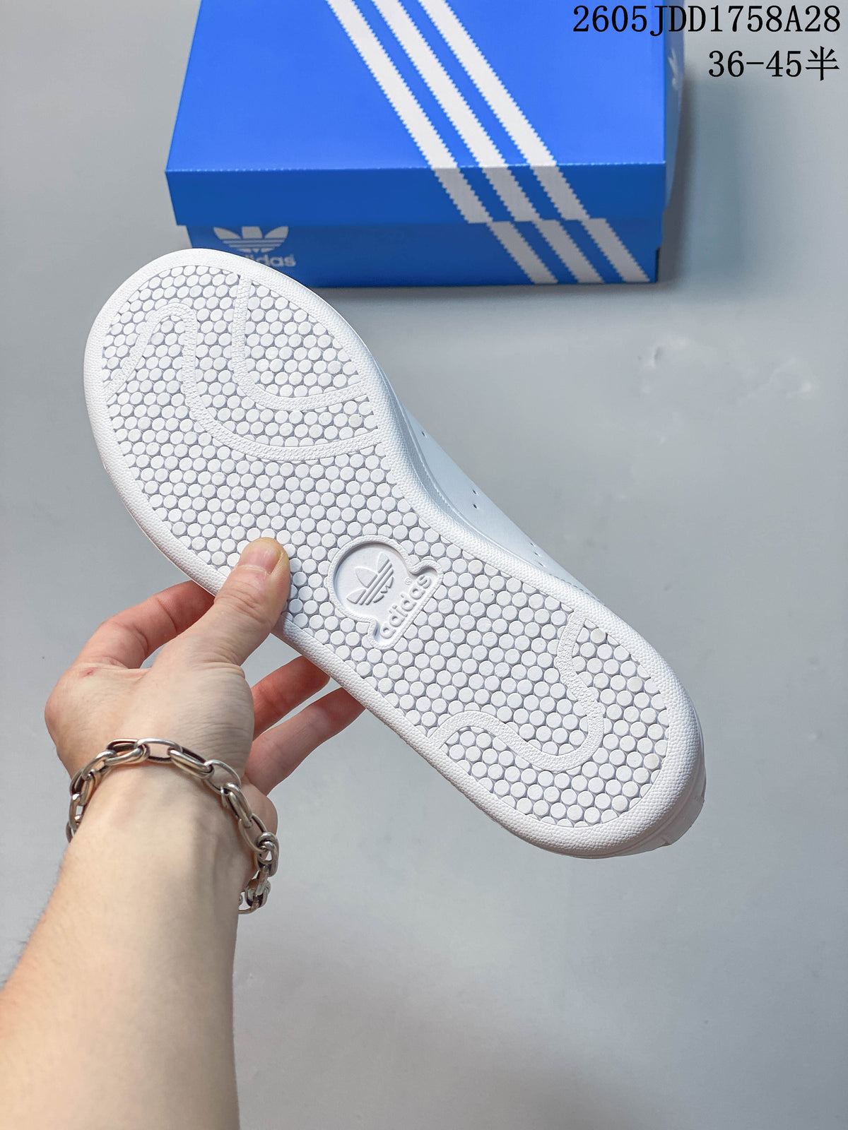 Close-up of the white textured outsole with circular tread pattern