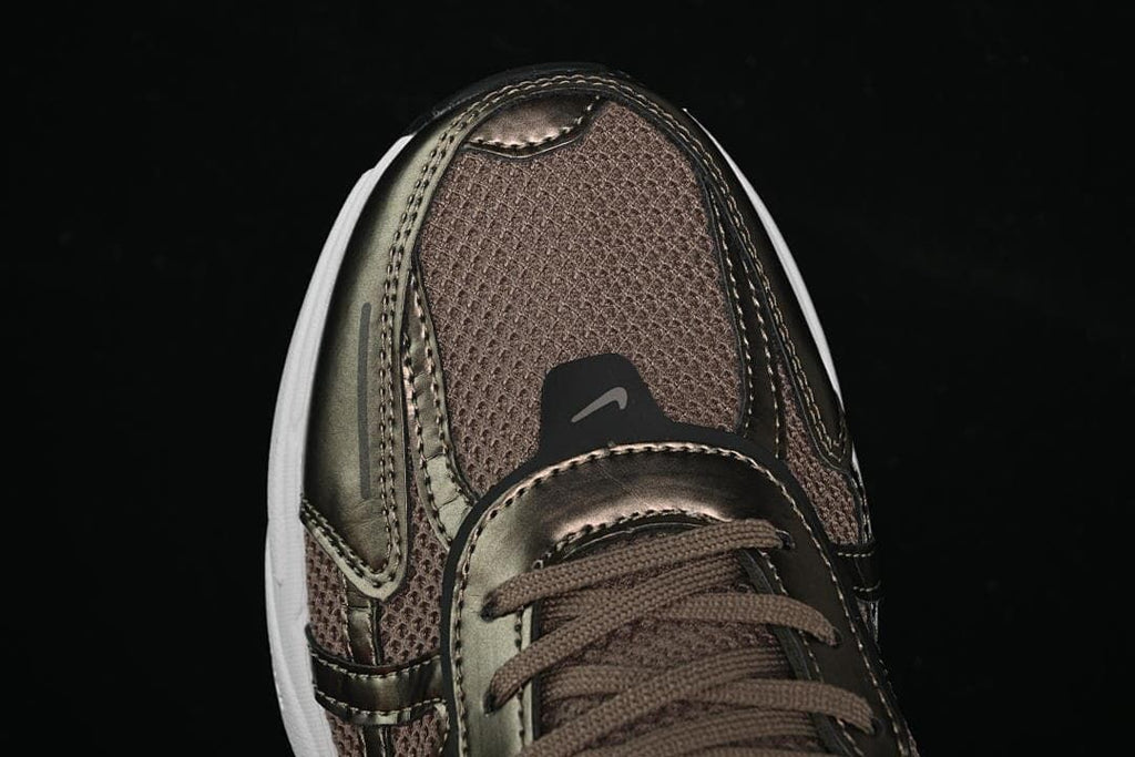 Top-front detail of the brown upper and metallic-look toe overlays