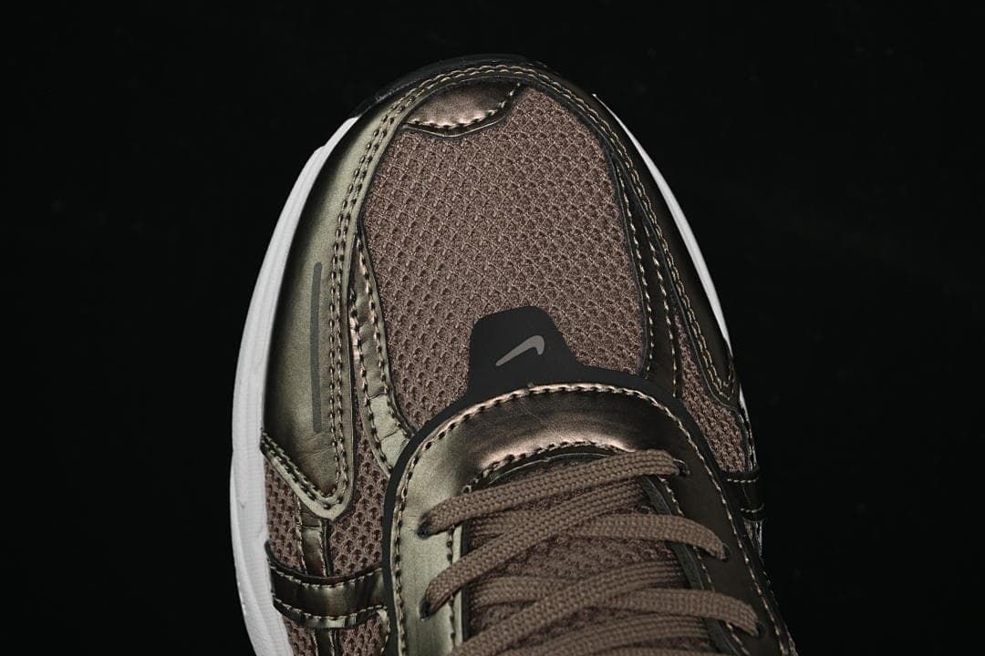Top-front detail of the brown upper and metallic-look toe overlays