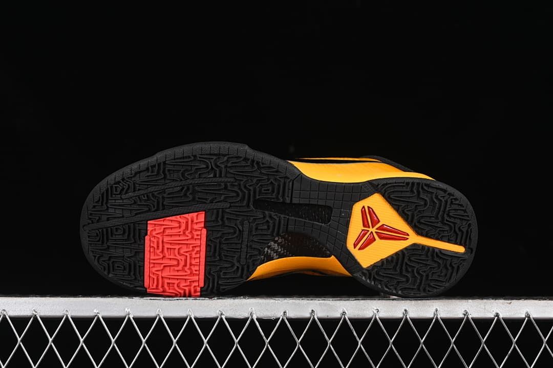 Underside view showing patterned black outsole and red traction section