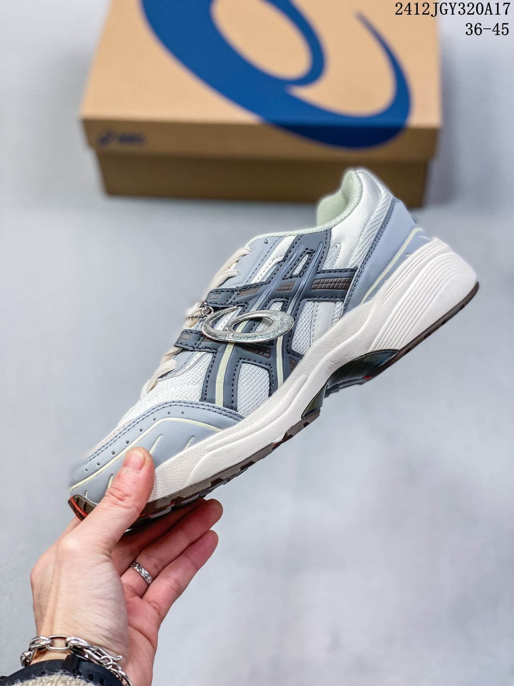 Side view of the white and grey sneaker with layered panels