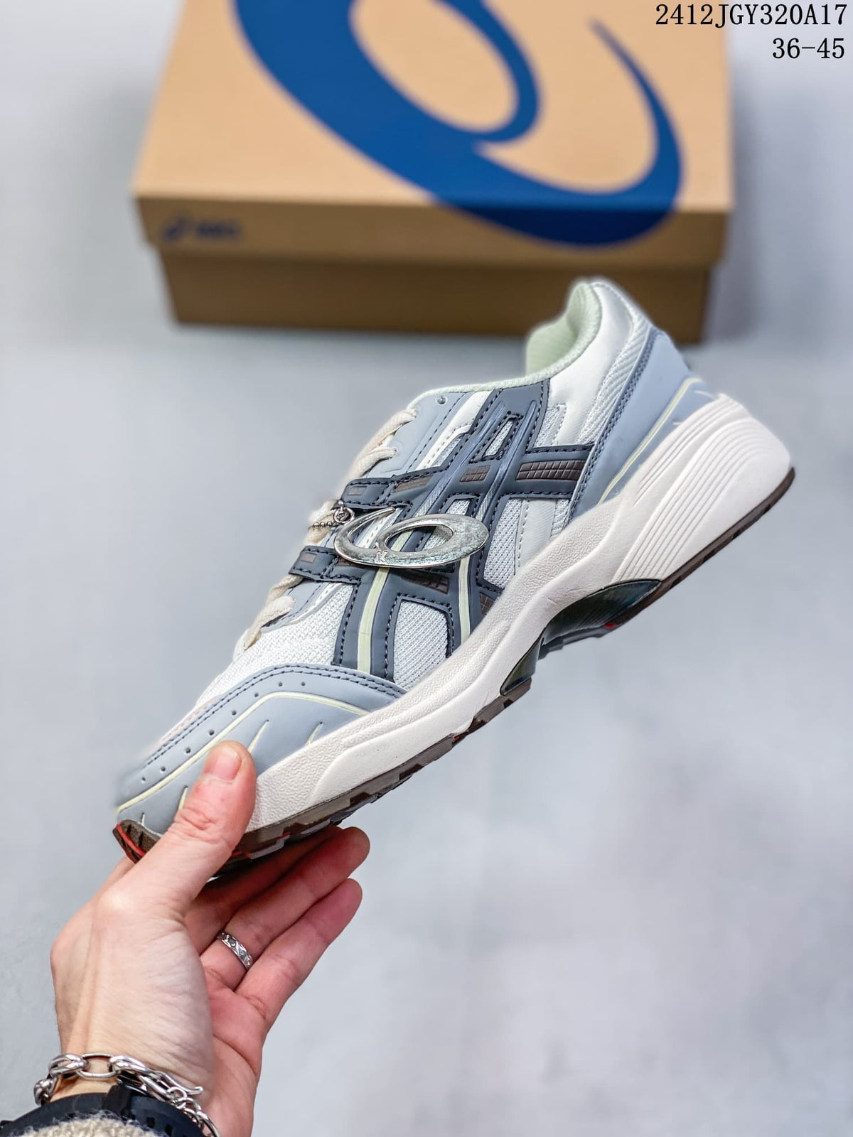 Side view of the white and grey sneaker with layered panels