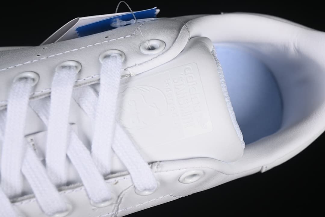 Close-up of the tongue, laces, and interior of the white sneaker