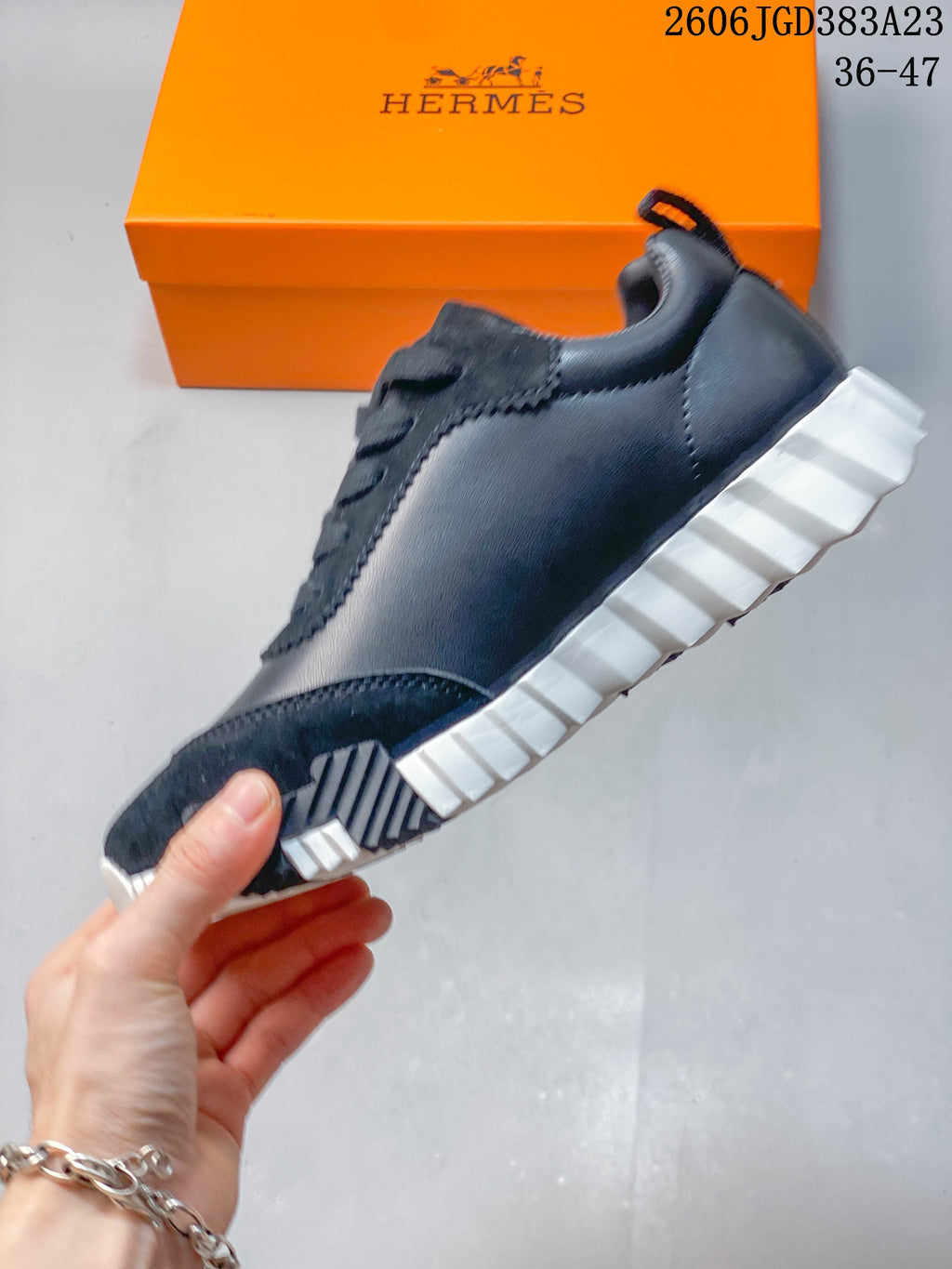 Side profile of a navy low-top sneaker showing paneling and a ridged white sole