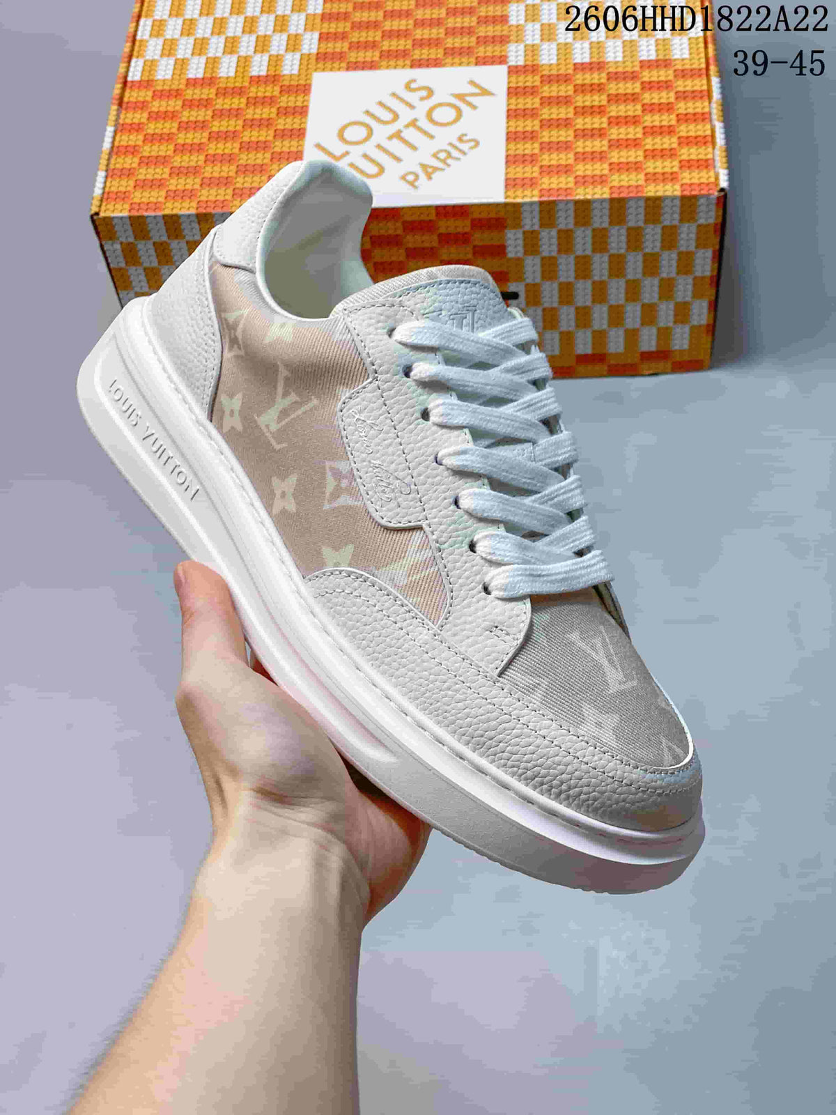 Angled view of the sneaker showing its light-colored upper and patterned side panel
