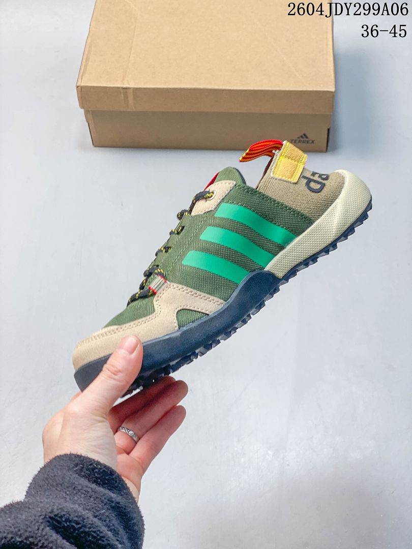 Side profile of the olive green lace-up shoe with bright green stripes and dark outsole