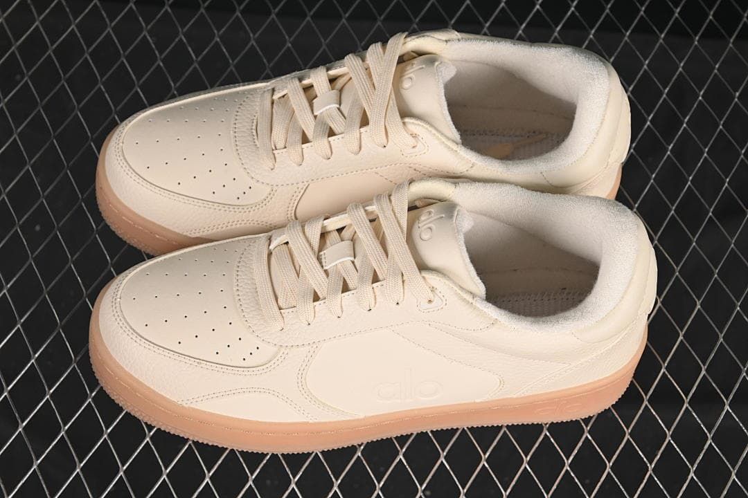 Pair of cream low-top sneakers with gum-tone soles