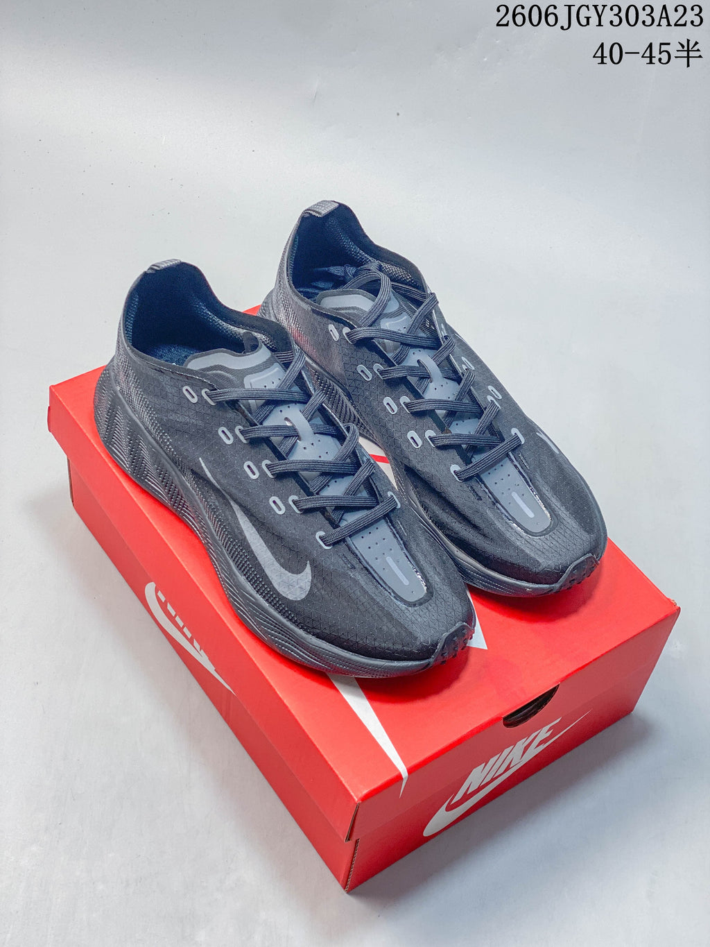 Pair of dark charcoal Nike Ava Rover low-top shoes on a red shoebox