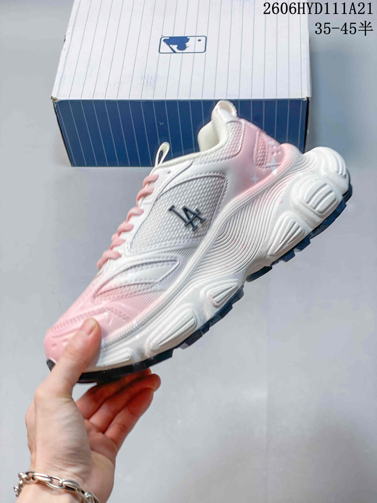 Side profile of a white and pink chunky sneaker with NY graphics.