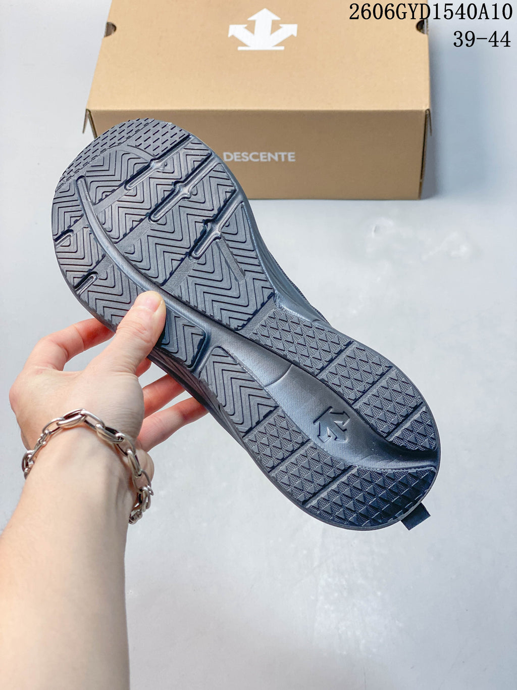 Close-up of the running shoe outsole showing a geometric tread pattern