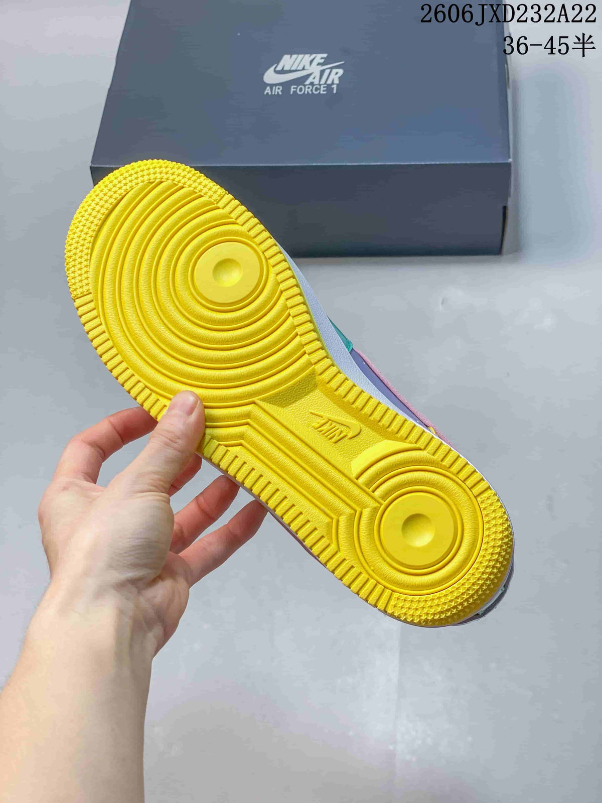 Underside of the sneaker showing a yellow patterned outsole