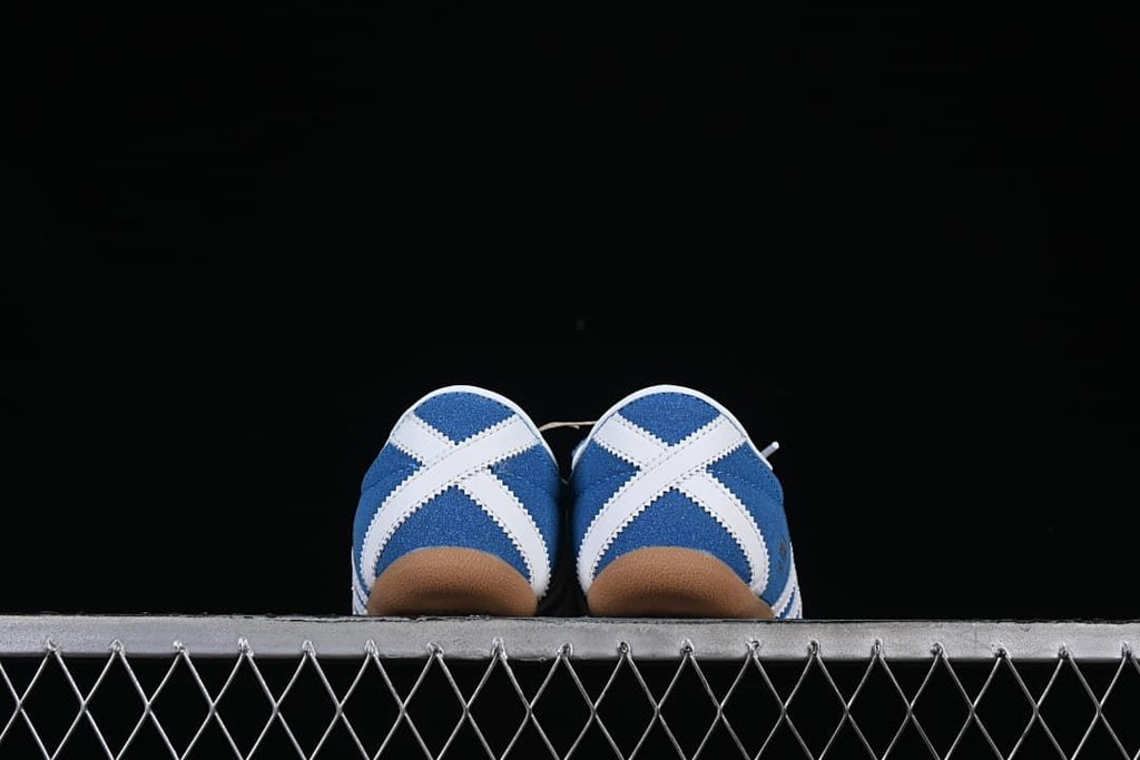 Rear view showing crossed white heel accents and gum-colored soles