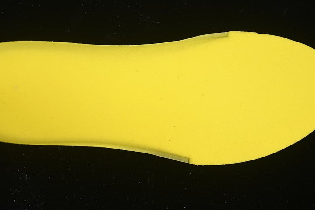 Close-up view of a bright yellow shoe insert.